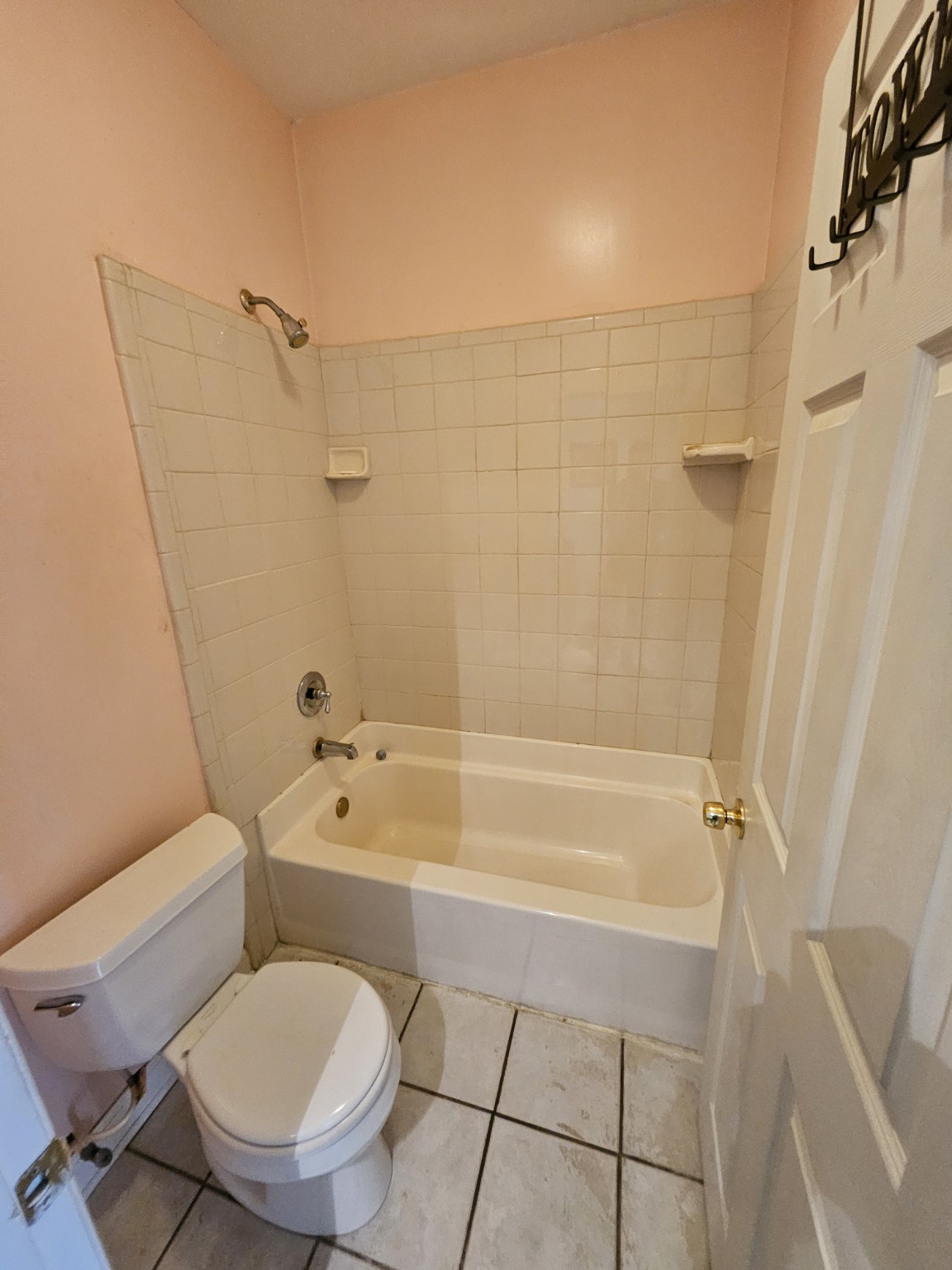 Bathroom before remodeling with a bathtub and white wall tile