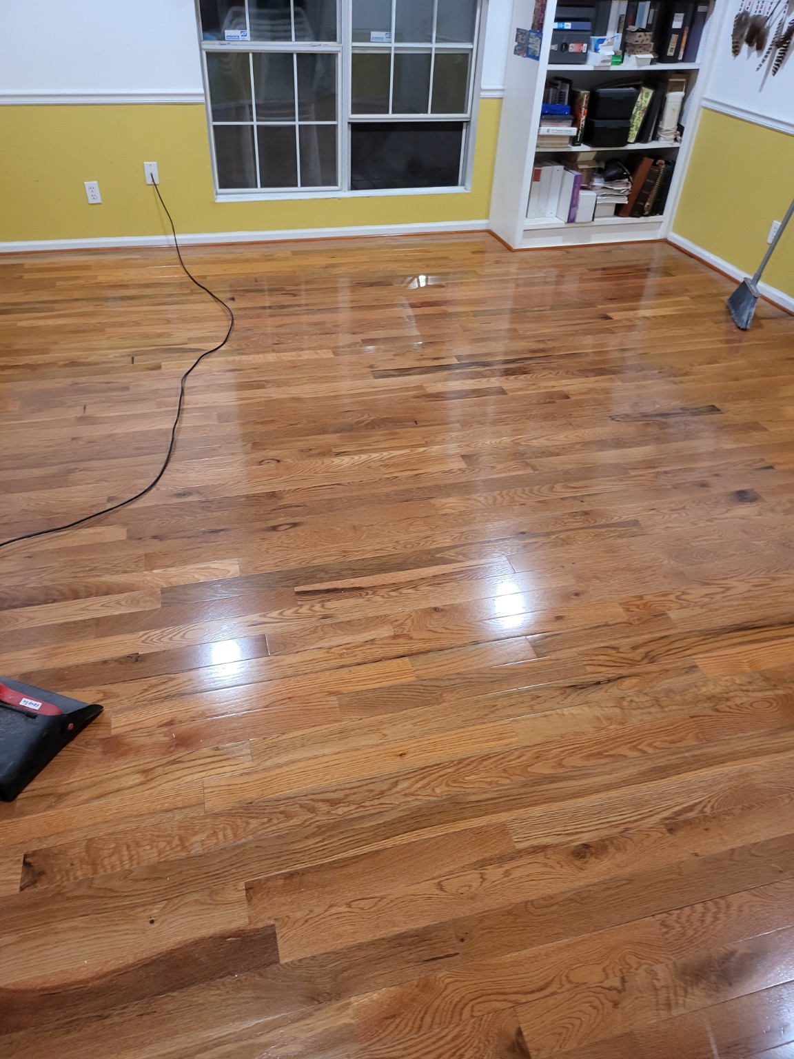 Polished hardwood flooring in a room with yellow walls