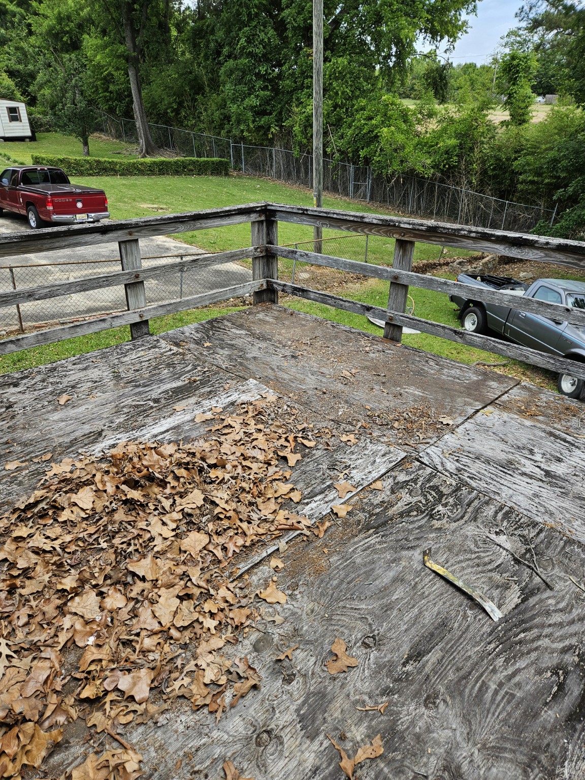 Weathered deck surface and railings before replacement