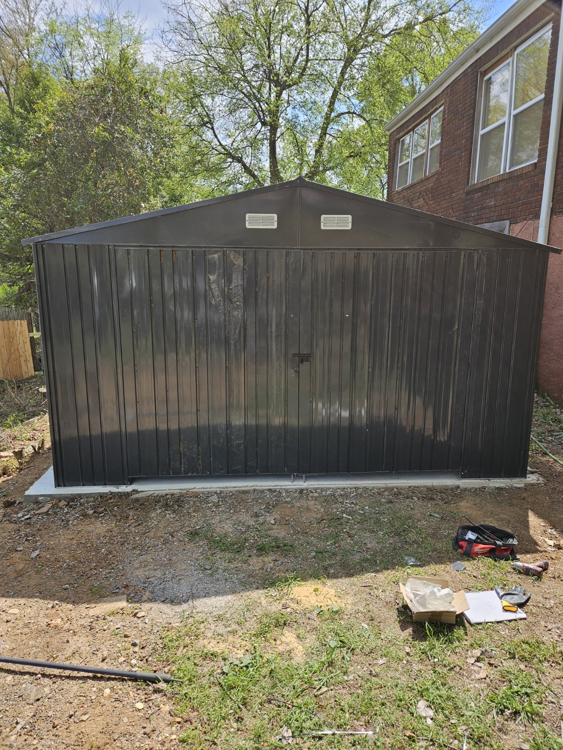 Finished dark metal outbuilding viewed from the front