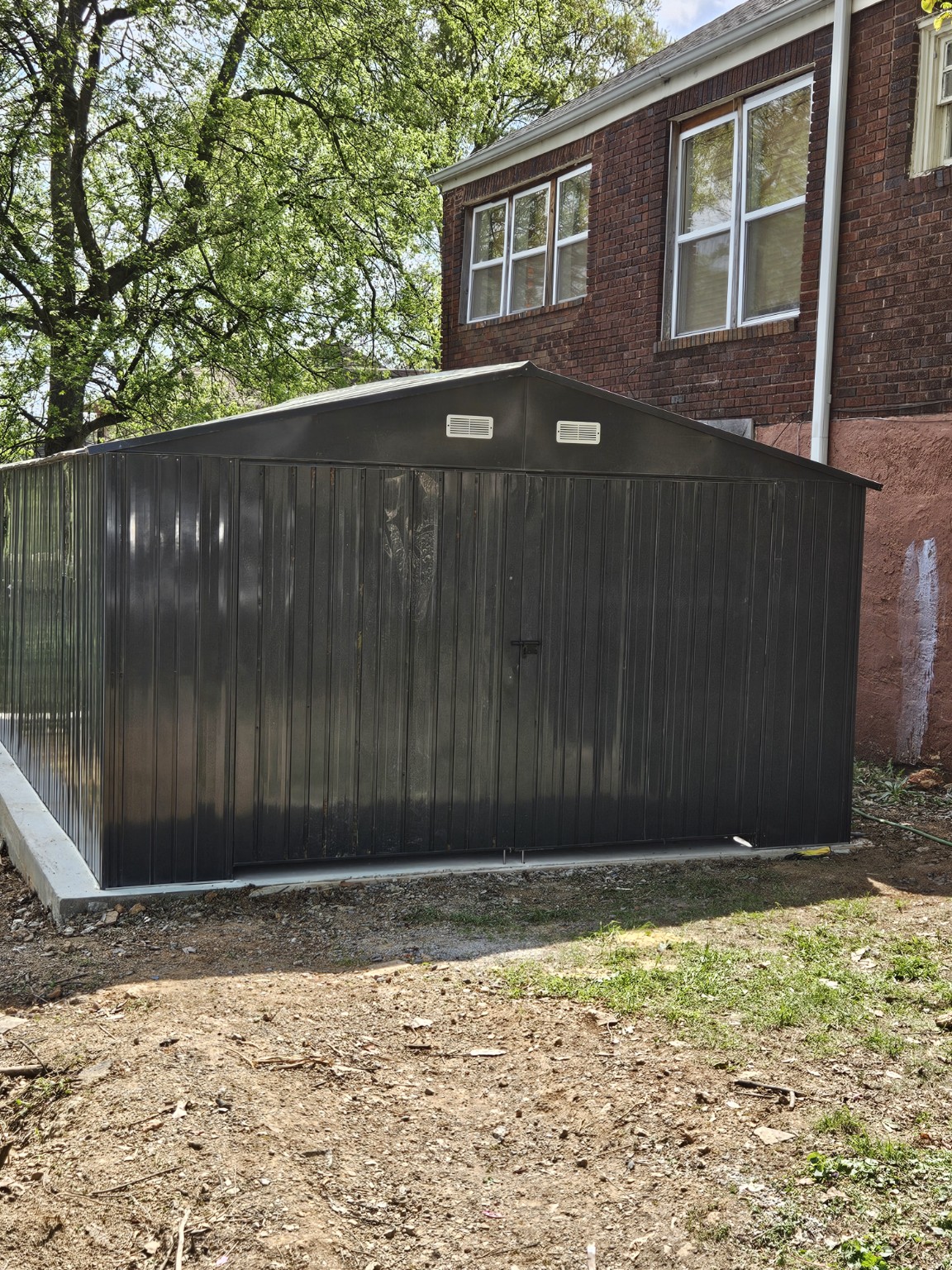 Finished dark metal outbuilding viewed from the side
