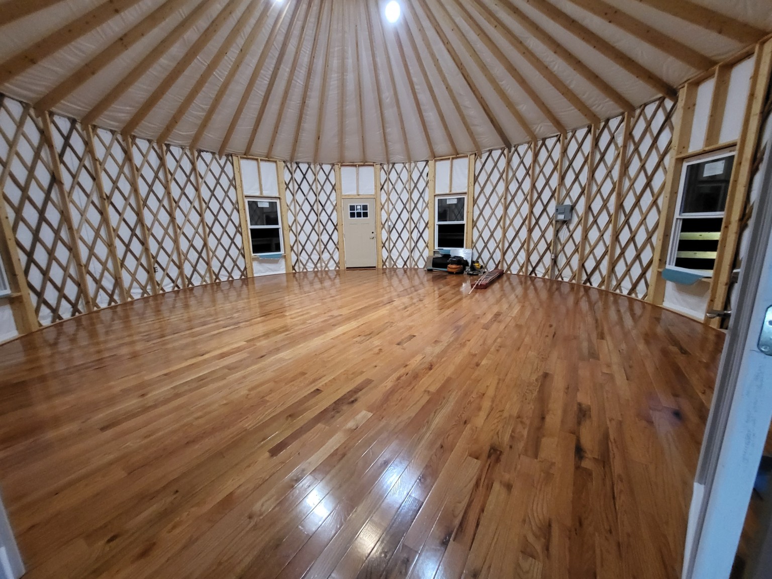 Yurt interior with wood floor and exposed lattice walls