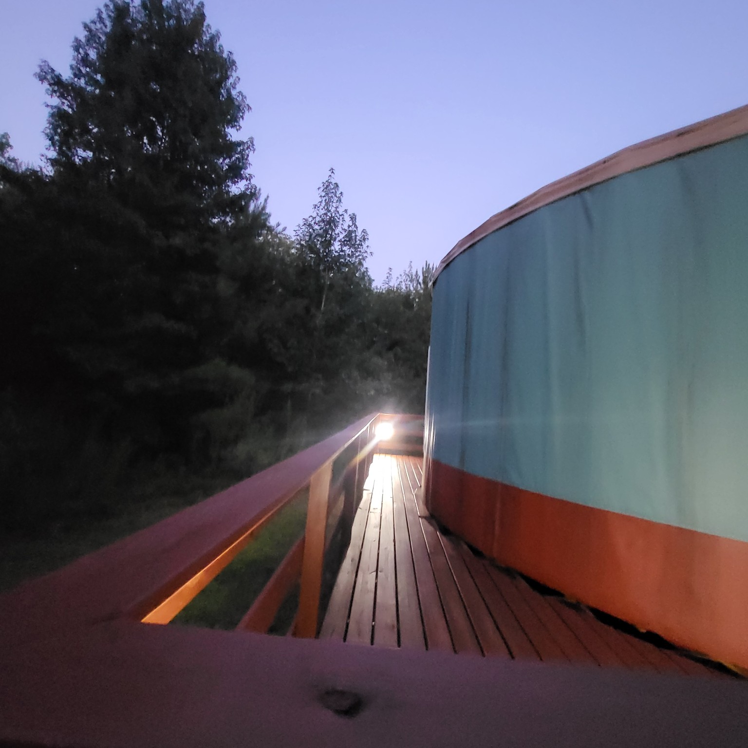 Narrow wraparound deck beside the yurt